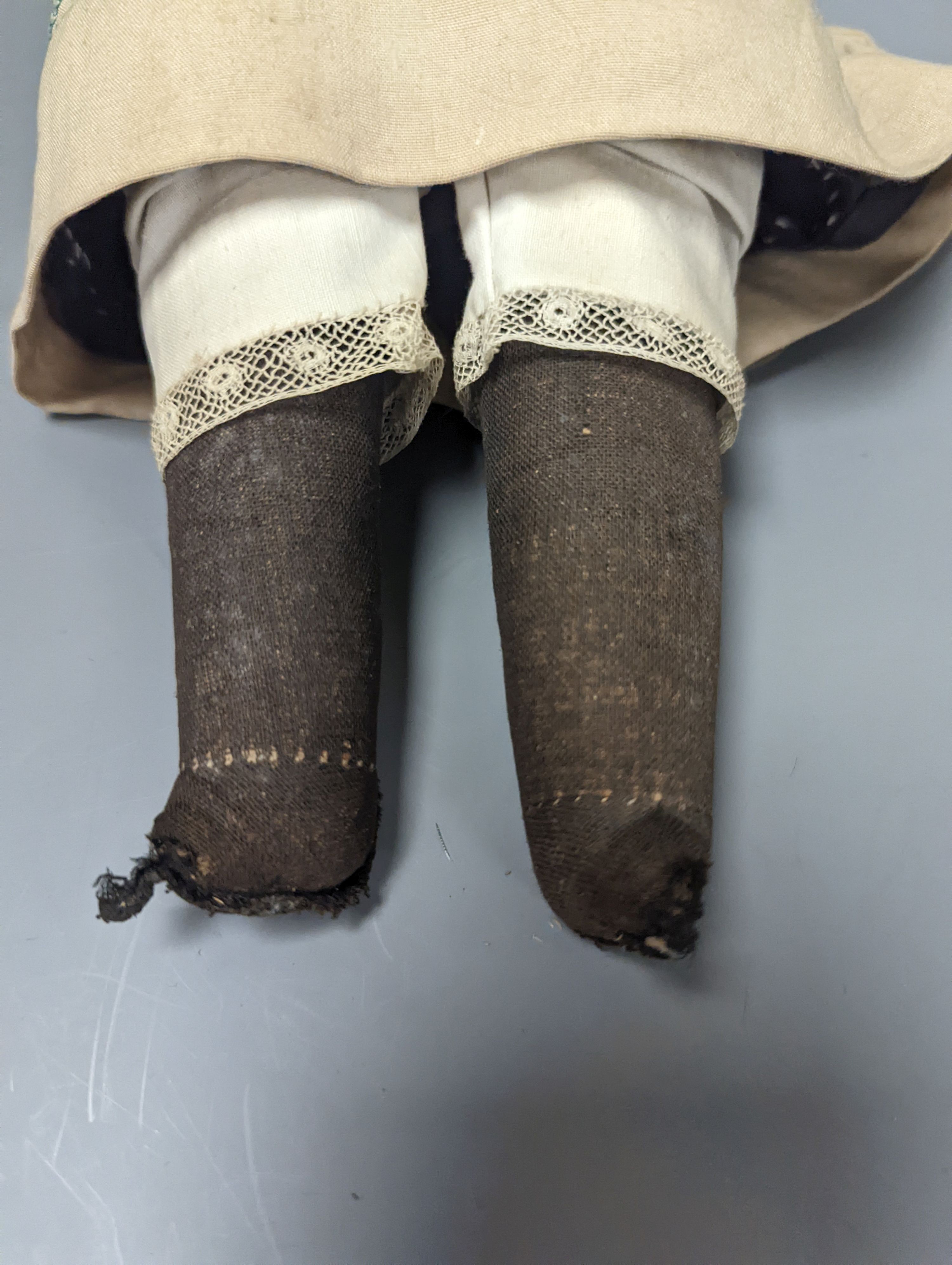 An Armand Marseille 370 bisque headed doll, wearing a basket weave boater and brown embroidered dress, 44cms high.